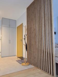 a room with a wooden wall and a glass door at Malta Delux Apartment, free parking, self check-in 24h in Poznań