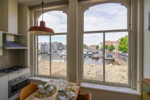 a kitchen with a window view of a harbor at 2L De Volharding in Leiden