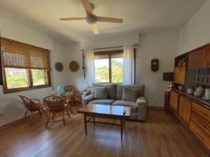 a living room with a couch and a table at ENTRETOXOS in Ribadavia