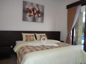 Postel nebo postele na pokoji v ubytování D' Kubu Pratama Homestay