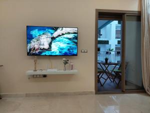 a living room with a tv on the wall at Central Park House - 70m² in Mohammedia