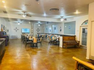 a dining room with tables and chairs in a room at The Classic Desert Aire Hotel in Alamogordo