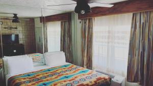 a bedroom with a large bed and a large window at The Classic Desert Aire Hotel in Alamogordo