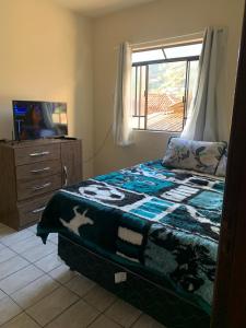 Ein Bett oder Betten in einem Zimmer der Unterkunft Cantinho Agradável em Ouro Preto