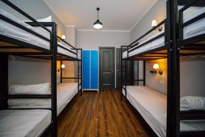 a dorm room with three bunk beds in it at Rose Hotel & Hostel Vake in Tbilisi City