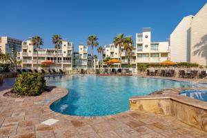 a swimming pool in the middle of a resort at Newly decorated condo in beautiful beachfront resort in South Padre Island