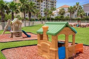 a playground with two play equipment in a park at Newly decorated condo in beautiful beachfront resort in South Padre Island