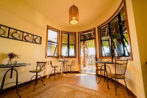 a living room with chairs and tables and windows at Fortmar Hotel in Fortaleza