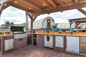 a kitchen with an outdoor kitchen with a stove at Zion White Bison Glamping & RV Resort in Virgin