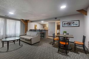 a living room with a couch and a table at Best Western Plus Como Park Hotel in Saint Paul