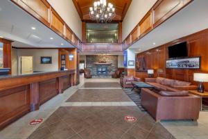 a lobby with leather furniture and a fireplace at Best Western Plus Meridian in Lloydminster