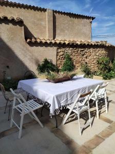 a table with a white table cloth and chairs at Guara VIVA Abiego in Abiego +28 photos
