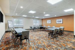 a conference room with tables and chairs on a rug at Best Western Plus Warsaw in Warsaw