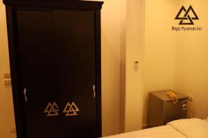 a room with a bed and a door at Magic Pyramids INN in Cairo