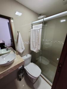 a bathroom with a toilet and a sink and a shower at Pousada Valparaiso in Petrópolis