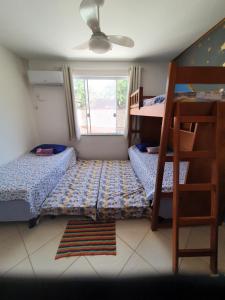 a bedroom with two bunk beds and a ladder at Cantinho dos Dalto in Itatiaia