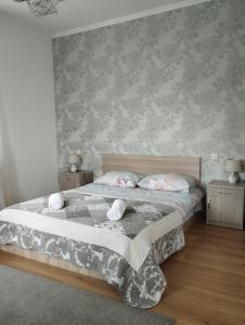 a bedroom with a bed with two night stands and two tables at Kazbek view guest house in Kazbegi