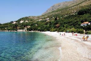 a group of people on a beach near the water at Apartments with a parking space Plat, Dubrovnik - 4776 in Mlini