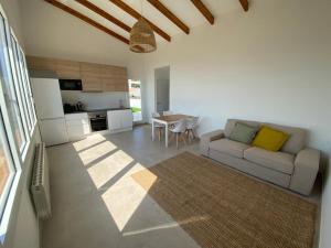 a living room with a couch and a table at Loft Casa Blanca in Blanes