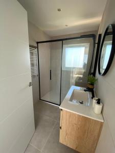 a bathroom with a sink and a glass shower at Loft Casa Blanca in Blanes