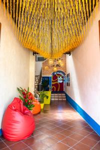a hallway with red bean bags in a building at Why Not Hotel in Antigua Guatemala