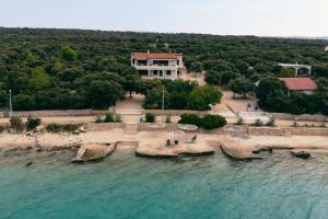 an aerial view of a house on the beach at Apartments by the sea Mandre, Pag - 6284 in Kolan