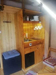 a small kitchen with a sink and a stove at Casa din "Curtea cu cai" in Borsec