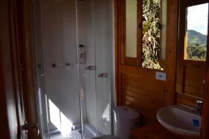 a bathroom with a shower and a sink at Arrecife Glamping in Guatavita