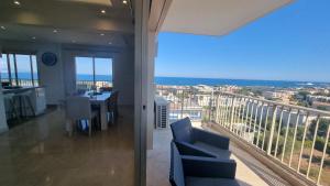 a room with a balcony with a view of the ocean at LUXURY APPARTEMENT Vue MER PANORAMIQUE in Antibes