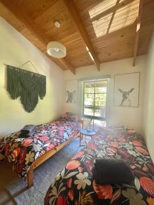 a bedroom with two beds and a window at Two Mountains Lodge - Modern Alpine Retreat with Spa - 3mins to Mt Buller in Mount Buller
