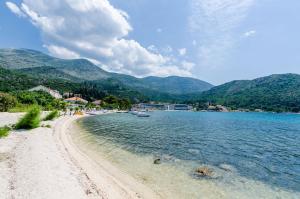 a view of a beach with mountains in the background at Apartments by the sea Slano, Dubrovnik - 8538 in Slano