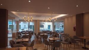 - un restaurant avec des tables et des chaises dans une salle dans l'établissement Hotel Alvarado Suites, à Salta