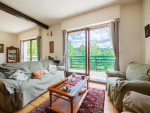 a living room with two couches and a table at Inviting holiday home in Miremont with garden in Miremont