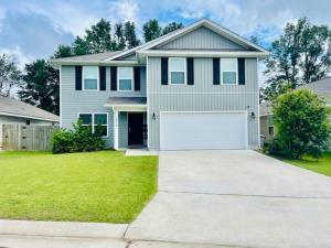 a large house with a white garage at Leny's Place in Pensacola