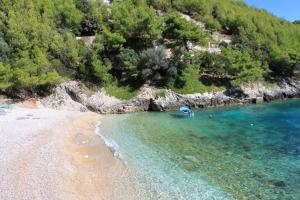 an aerial view of a beach with a tent in the water at Secluded fisherman's cottage Cove Bratinja Luka, Korcula - 9224 in Korčula