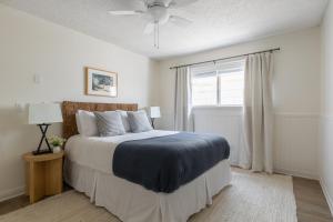 a bedroom with a large bed and a window at Bay View II by AvantStay Ocean View Mission Beach Home on the Sand in San Diego