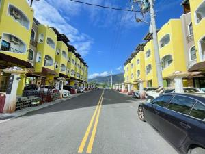 a car parked on the side of a street with buildings at 蘑菇村-童心未泯民宿 in Taitung City