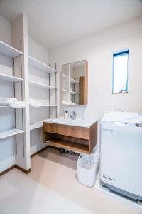 a bathroom with a sink and a mirror at HANASTAY花渓居 · 川（KAWA） in Osaka