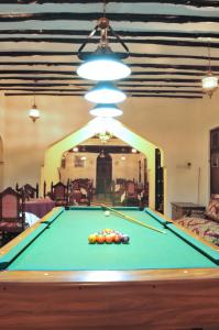 a pool table with balls on it in a room at Dhow Palace Hotel in Zanzibar City