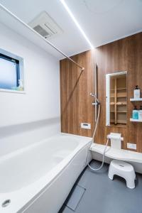 a bathroom with a shower and a toilet in it at HANASTAY花渓居 · 川（KAWA） in Osaka