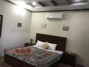 a bedroom with a bed and a air conditioner at SWAT HILL VIEW RESORT- only for families in Swat