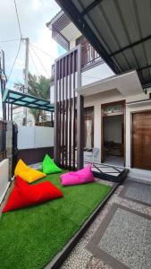 a group of colorful objects laying on the grass in front of a house at Oemah Wisata RinginSari -Full House, 5 Bed Rooms- in Kalasan