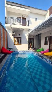 a large swimming pool in front of a building at Oemah Wisata RinginSari -Full House, 5 Bed Rooms- in Kalasan