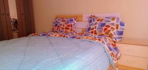 a bedroom with a bed with a colorful comforter at Fully Furnished Apartment in Chililabombwe in Chililabombwe