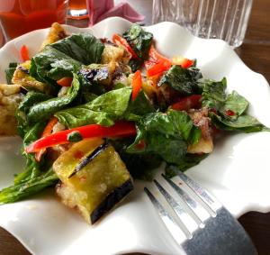 a white plate with a salad and a fork at Nurgul in Bokonbayevo