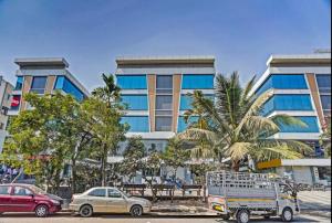a large building with cars parked in front of it at Hotel Santeria Inn, Best Luxurious Hotel AC Rooms In Surat in Surat