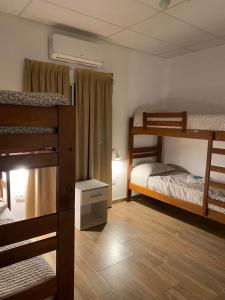 a room with three bunk beds in a dorm at Bitcoin's House II. Laguna Brava in Corrientes