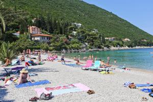 a group of people sitting on a beach at Apartments by the sea Trpanj, Peljesac - 14309 in Trpanj