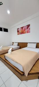 Giường trong phòng chung tại Api-Api GuestHouse