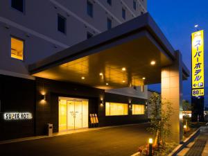 a building with a sign that reads cyber hotel at Super Hotel Shikoku-chuo in Shikokuchuo